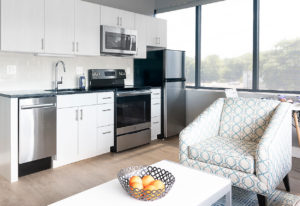 Kitchen cabinets and counters in the one-bedroom units at The Borden Luxury Apartments.