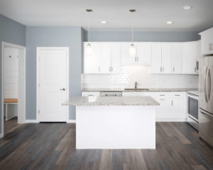 Residences On Main kitchen with CNC Luxor perimeter cabinets and island in White.