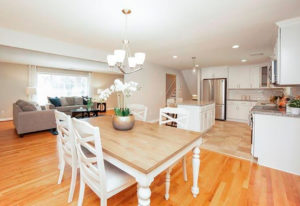 View across the dining area of the new cabinets and counters in the kitchen in a West Hartford property rehab by Oculus Construction.