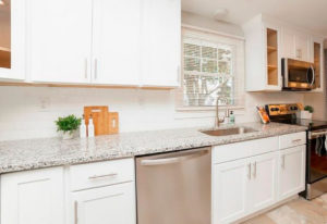 Perimeter cabinets and counters in the kitchen of a West Hartford property rehab by Oculus Construction.