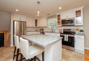 New cabinets and counters in the kitchen in a West Hartford property rehab by Oculus Construction.